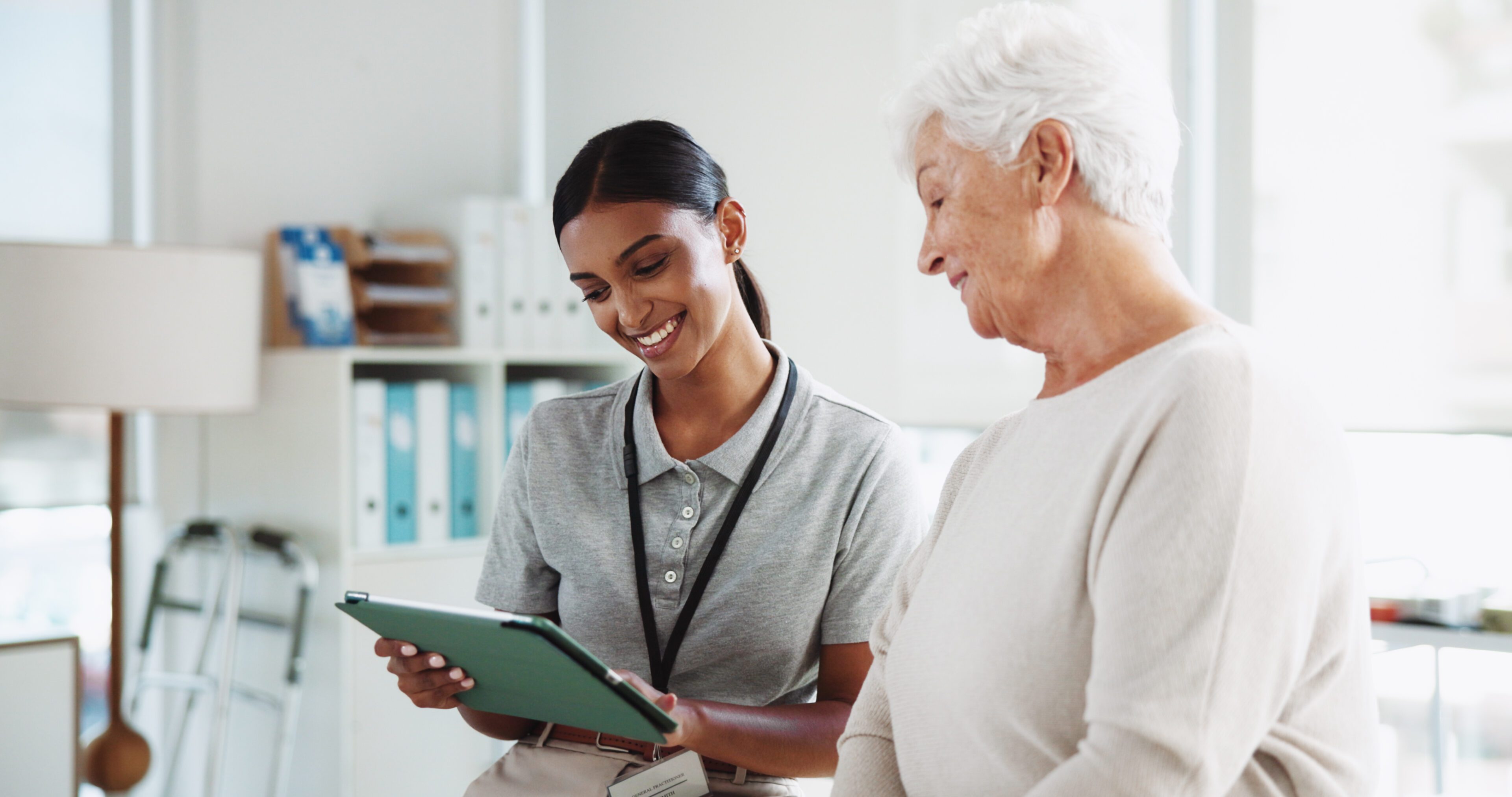 Physiotherapy, tablet and person with senior woman for medical results, consulting and diagnosis. Physical therapy, chiropractor and person on digital tech for mobility, treatment and rehabilitation
